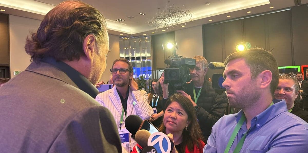 Marc Benioff takes questions from press during the Salesforce Slackbot product launch event at the St. Regis Hotel in San Francisco, March 31, 2026. Reporters, camera crews, and analysts surround the Salesforce CEO in a post-keynote press scrum, with ABC7 microphone visible. Photo credit: Vernon Keenan / SalesforceDevops.net
